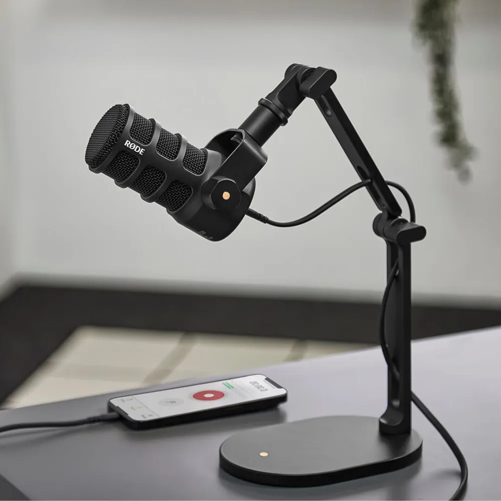 PodMic USB on a desk stand recording into a smartphone app